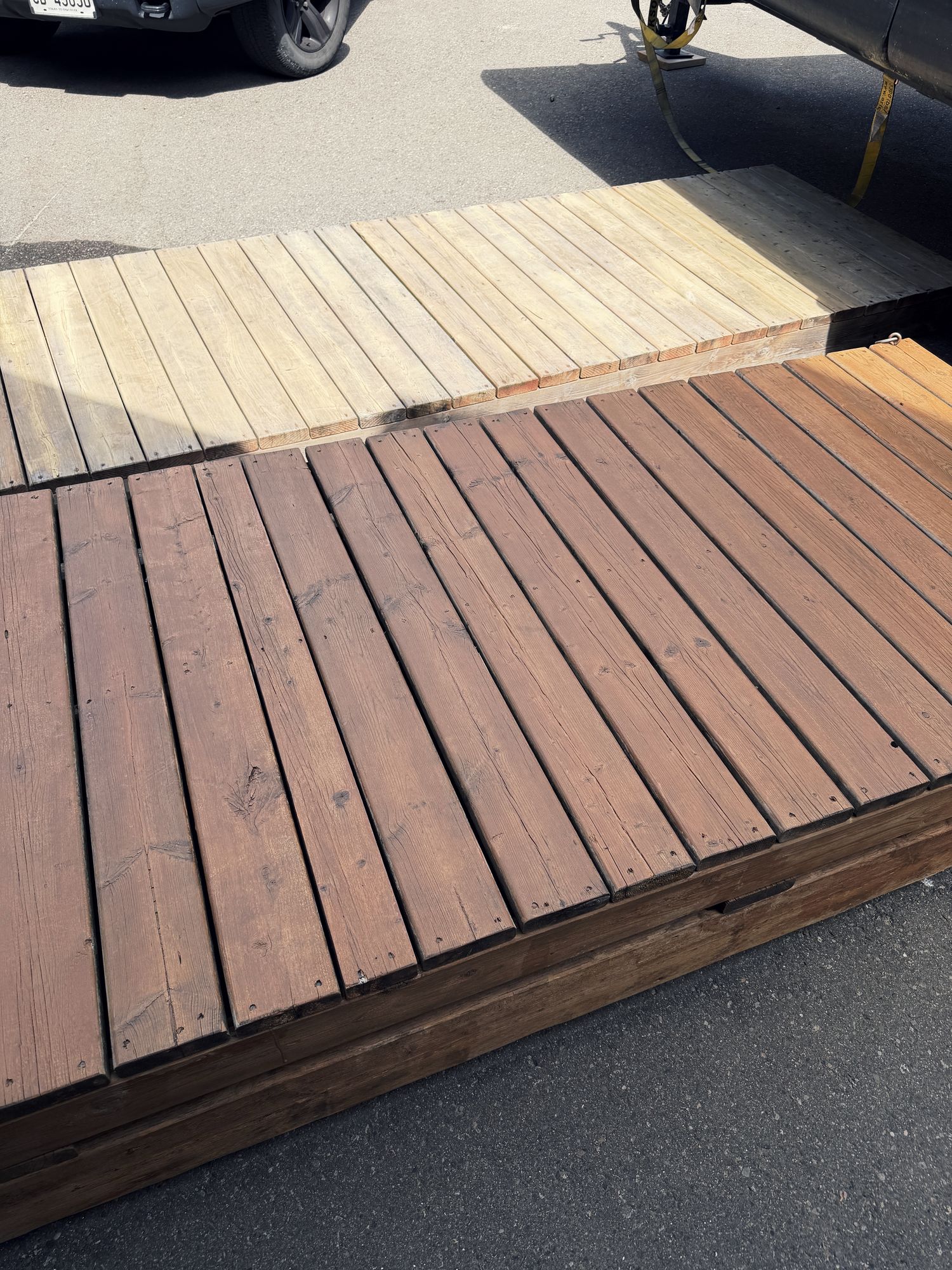 One run of cedar dock boards, half weathered grey and half freshly cleaned and stained